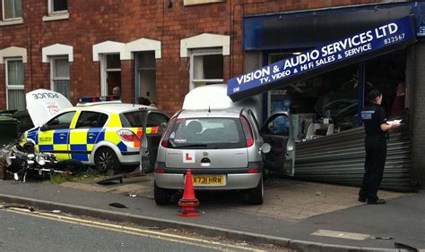 Police car crashes into shop front