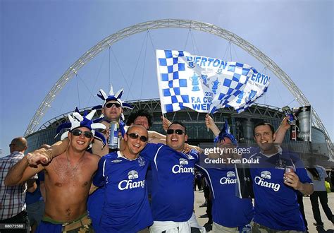 A group of Everton supporters are shown awaiting entry to the stadium ...