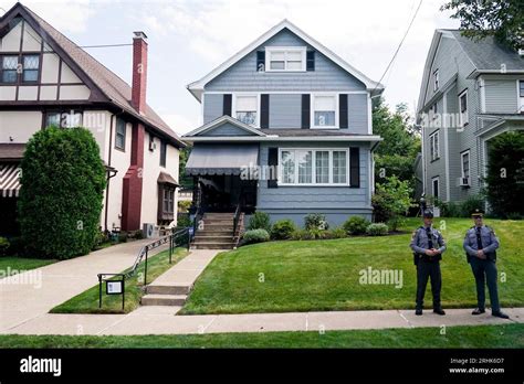 Officers stand outside President Joe Biden's childhood home, center, as the motorcade for ...