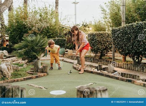 Group of Two Funny Kids Playing Mini Golf Stock Image - Image of family ...