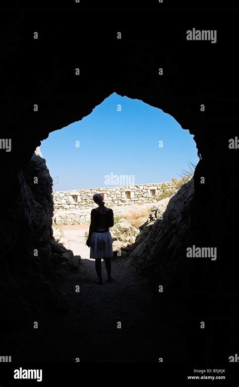 Woman silhouette standing inside cave Venetian Fortress Fortezza Rethymno Crete Greece September ...