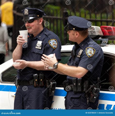 Two Police Officers while Drinking a Cup of Coffee in NYC. Editorial ...