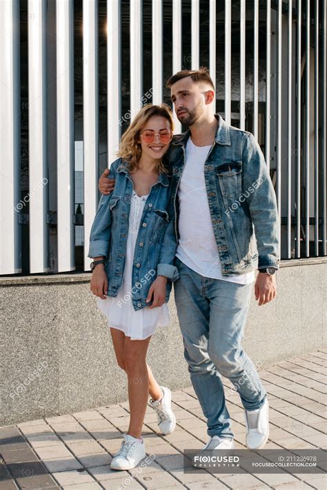 Young adult couple wearing casual clothing strolling outdoors — style ...