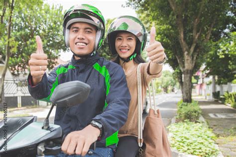 commercial motorcycle taxi driver and his passenger showing thumb up Stock Photo | Adobe Stock