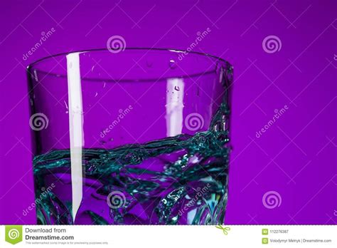 The Water Splashing in Glass on Lilac Background Stock Image - Image of food, energy: 112276387