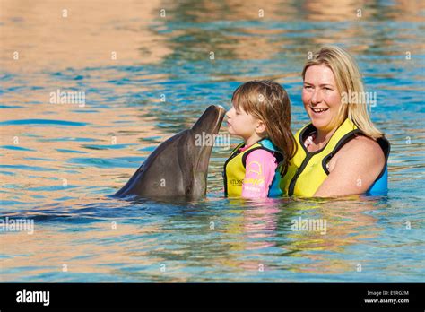 Mother And Daughter Enjoying A Dolphin Encounter Dolphin Bay The Atlantis Hotel The Palm Dubai ...