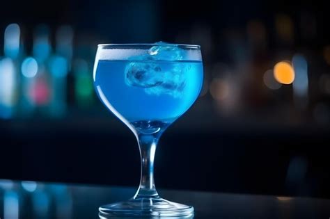 Premium Photo | A blue cocktail with ice cubes in a tall glass.