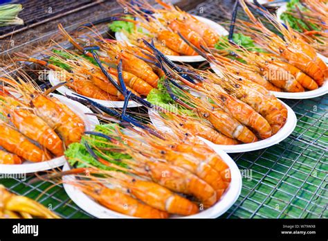 Grilled shrimps of seafood Street food of Thailand on the table in market of Bangkok Thailand ...