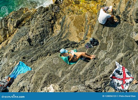 People Sitting At The Beach On A Cliff In Manarola, Italy Editorial ...