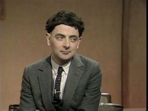 a man in a suit and tie sitting down