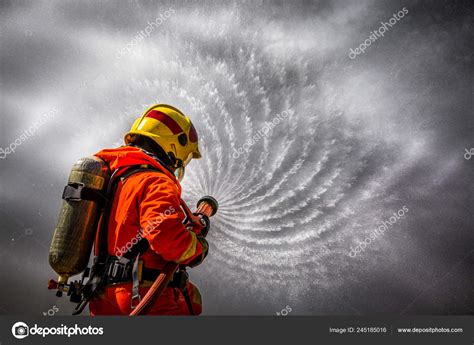 Firefighter Using Extinguisher Water Hose Fire Fighting Firefighter Spraying High Stock Photo by ...