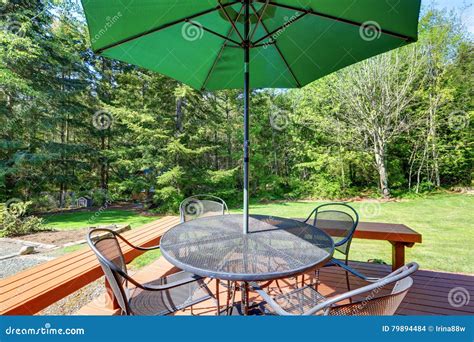 Black Wrought Iron Patio Set with Open Umbrella Stock Photo - Image of design, house: 79894484