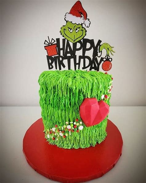 a green cake decorated with grass and the words happy birthday