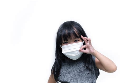 Premium Photo | Asian cute little girl wear mask on white backgrounda girl wearing protection ...