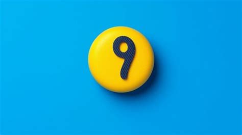 Premium AI Image | A close up of a yellow button with a black number 9 on it generative ai