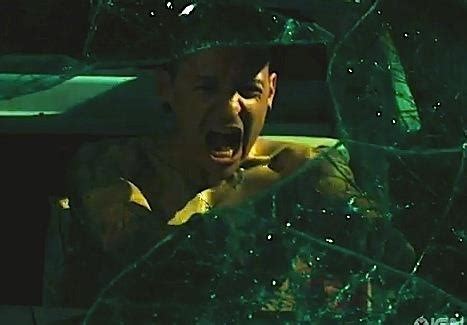 a young boy is screaming in the back seat of a car with shattered glass ...