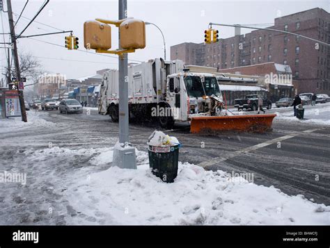 A snow plow clears snow from a street in New York City Stock Photo - Alamy