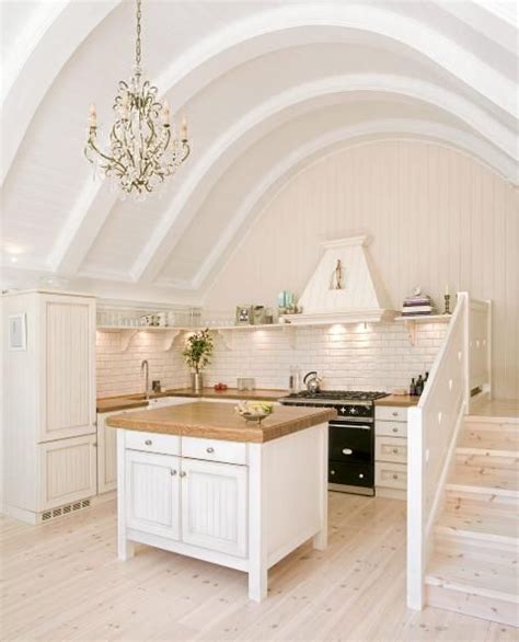 Barrel ceiling in Norweigian kitchen with a beautiful matte black Cluny with brass trim. http ...