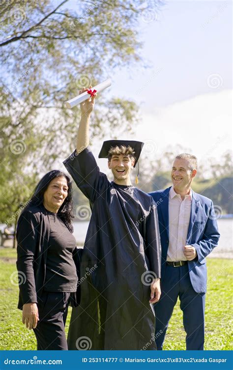 Young Recently Graduated Boy, Dressed in Cap and Gown, with His Degree in Hands Stock Image ...