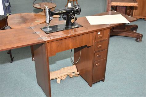 1960's walnut single pedestal sewing machine cabinet with Singer sewing machine