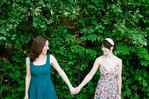 "Two Women Holding Hands In Park" by Stocksy Contributor "Jennifer Brister" - Stocksy