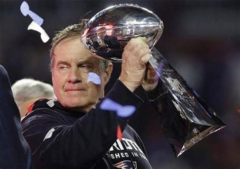 New England Patriots head coach Bill Belichick holds up the Vince ...