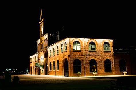 Brown Brick Building With Lights during Night Time · Free Stock Photo