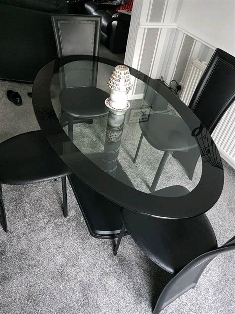 Oval glass dining table and four chairs | in Falkirk | Gumtree