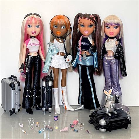 four dolls are lined up next to each other with luggage and earphones on the floor