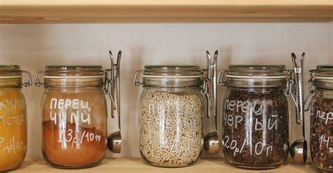 Variety of Spices in Glass Jars on Wooden Shelves · Free Stock Photo
