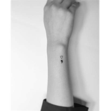 Minimalistic style semicolon heart tattooed on the