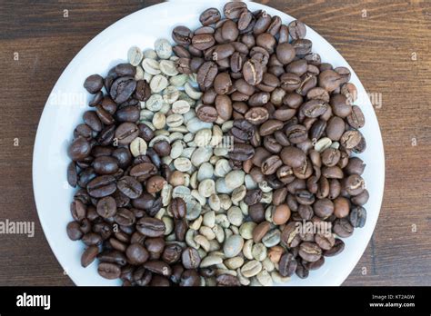 Three Types Of Roasted and Unroasted Coffee Beans On Plate Stock Photo ...