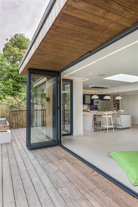 Bi-fold doors | inside outside | level threshold | timber decking | timber clad roof overhang ...