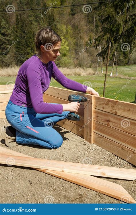 Woman Screwing Wooden Frame for a Raised Garden Bed Stock Image - Image ...