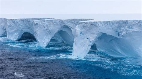 Striking photos show arches and cavernous hollows carved into world’s largest iceberg ...