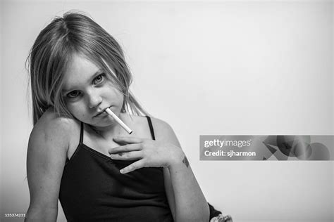 Portrait Young Girl With Cigarette In Mouth Looking At Camera High-Res Stock Photo - Getty Images