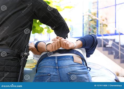 Police Officer Arresting Criminal Near Car Stock Photo - Image of guilt, duty: 157911408