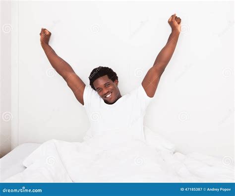 Young Man Waking Up At Bedroom Stock Photo - Image: 47185387