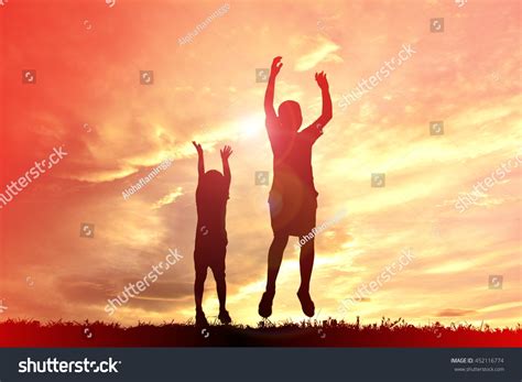 Silhouette Children Playing On Sunset Stock Photo (Edit Now) 452116774