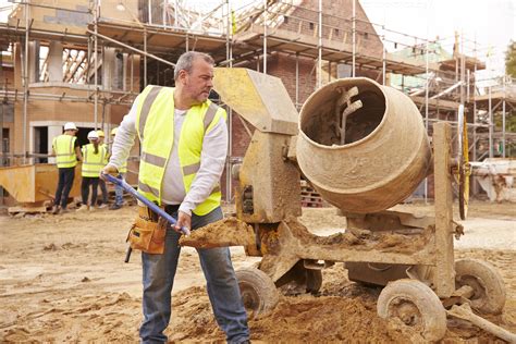 Construction Worker On Building Site Mixing Cement 903398 Stock Photo ...