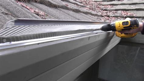 Installing Stainless Steel Gutter Guards on soft metal roof - YouTube