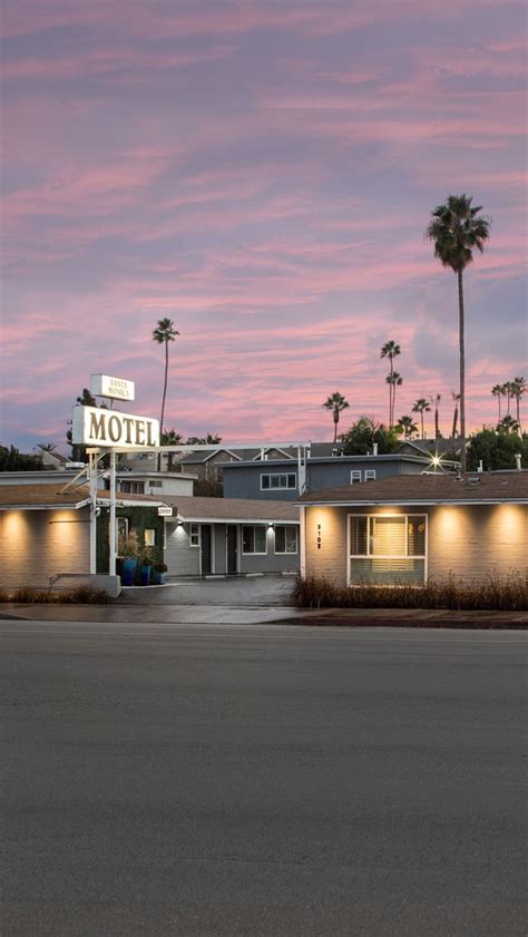 motel with palm trees in the background at dusk