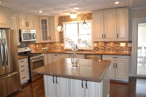 a large kitchen with white cabinets and stainless steel appliances ...