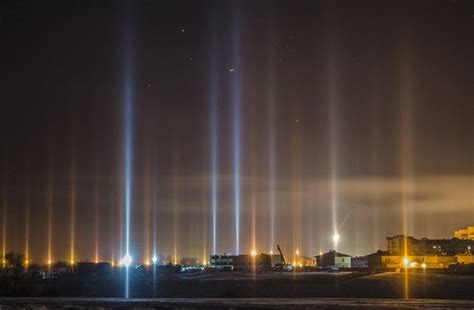 Mysterious light pillars form columns of light beaming towards the sky ...