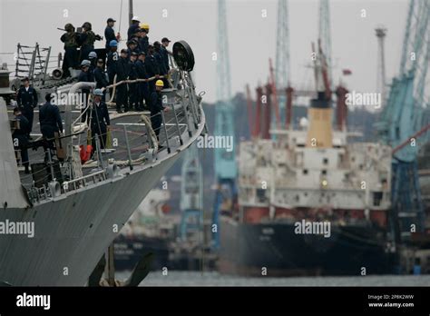 Sailors stand on deck of the USS Bainbridge as it sails into Mombasa ...