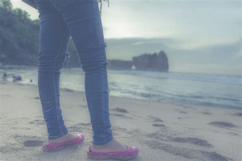 Person in Blue Jeans and Pink Flats in Front of Seashore · Free Stock Photo