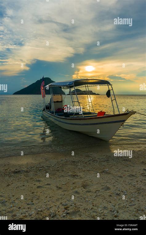 Boat with sunset background Stock Photo - Alamy