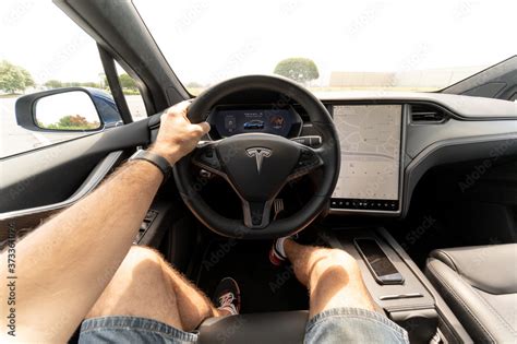 Person driving a new Tesla SUV. The interior of a full-sized, all ...