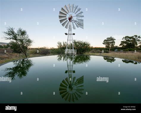 Farm dam and windmill in Merweville in the Karoo region of South Africa ...