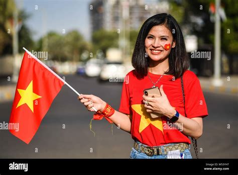 A fan of Vietnam holds up a national flag to show support for Vietnam ...